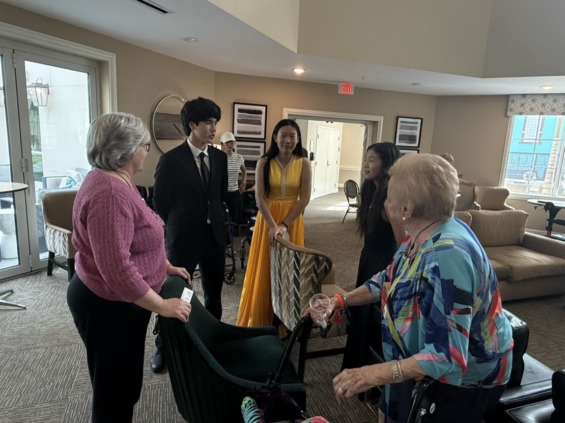 OCAPEX students greeting community members before a visit