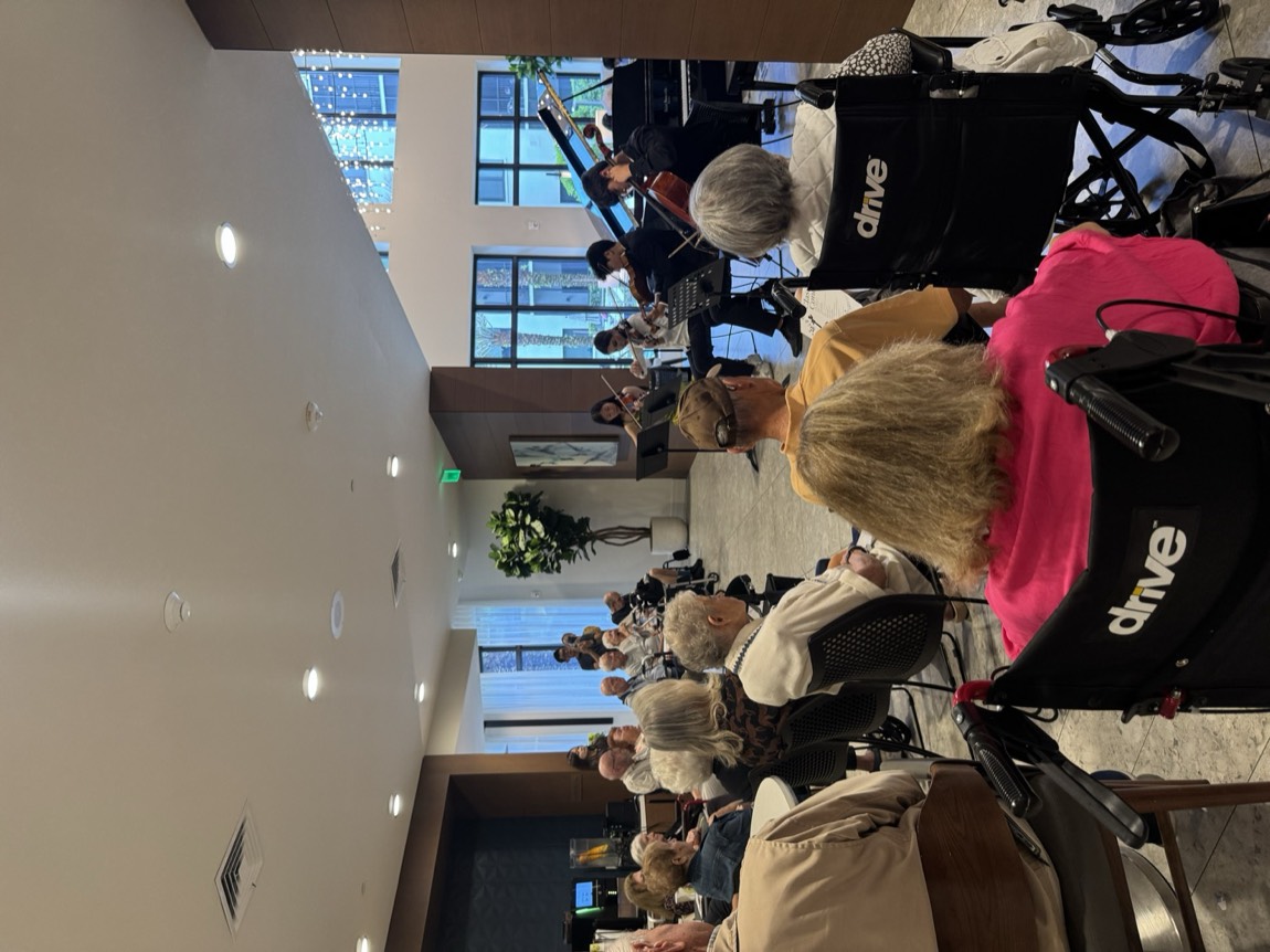 OCAPEX student musicians performing for a room of elderly community members