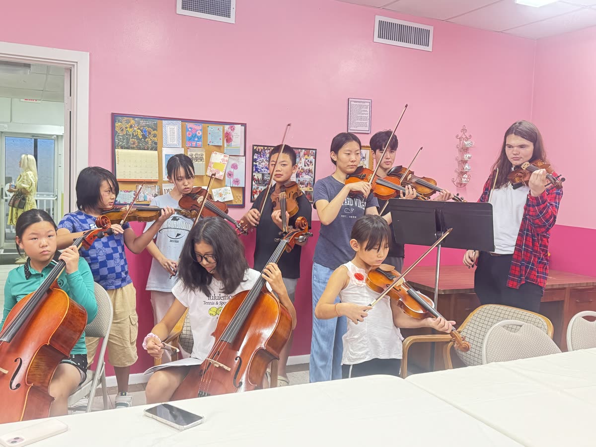 OCAPEX students of all ages playing violin and cello together at the first Music Mentorship session